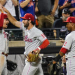 
              Philadelphia Phillies' Matt Vierling, center, celebrates with teammates Bryson Stott, left, and Jean Segura after throwing out New York Mets' Starling Marte at home plate to end the ninth inning of a baseball game Friday, Aug. 12, 2022, in New York. (AP Photo/Frank Franklin II)
            