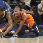 
              Connecticut Sun forward Alyssa Thomas (25) and Dallas Wings center Teaira McCowan (7) reach for the loose ball during the first quarter of Game 3 of a WNBA first-round playoff series basketball game in Arlington, Texas, Wednesday, Aug. 24, 2022. (AP Photo/LM Otero)
            