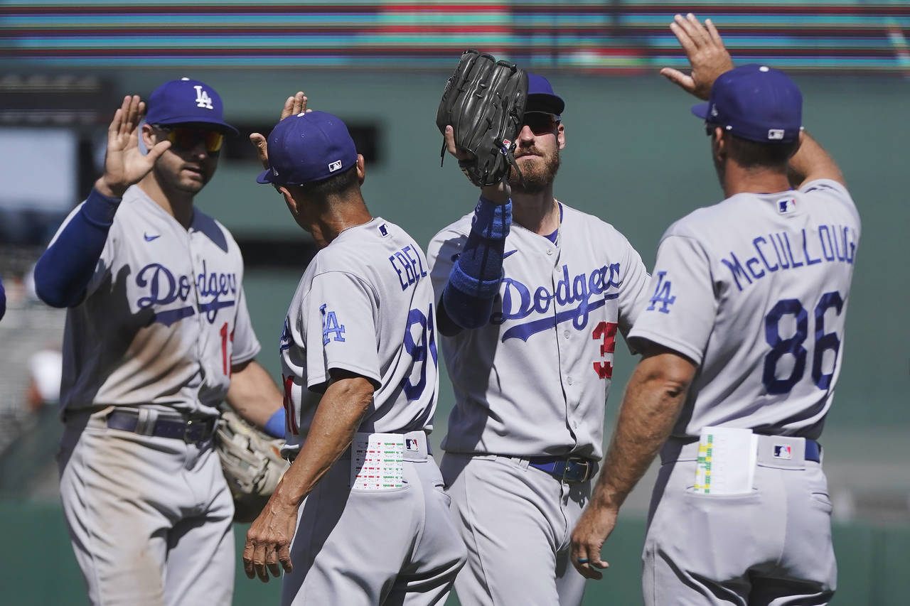 Los Angeles Dodgers' Joey Gallo, left, third base coach Dino Ebel, Cody Bellinger and first base co...