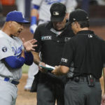 
              Los Angeles Dodgers manager Dave Roberts talks to umpires Angel Hernandez and James Hoye during the eighth inning of a baseball game against the Miami Marlins, Friday, Aug. 26, 2022, in Miami. (AP Photo/Marta Lavandier)
            
