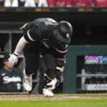 
              Chicago White Sox's Josh Harrison slaps the ground after his inning-ending popup during the seventh inning of the team's baseball game against the Houston Astros on Monday, Aug. 15, 2022, in Chicago. (AP Photo/Charles Rex Arbogast)
            