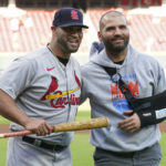 
              St. Louis Cardinals' Albert Pujols, left, poses with Cincinnati Reds' Joey Votto during a ceremony to honor Pujols' upcoming retirement, prior to a baseball game Wednesday, Aug. 31, 2022, in Cincinnati. (AP Photo/Jeff Dean)
            