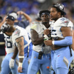 
              Tennessee Titans defensive end DeMarcus Walker, right, talks with quarterback Malik Willis during the second half of a preseason NFL football game against the Baltimore Ravens, Thursday, Aug. 11, 2022, in Baltimore. (AP Photo/Gail Burton)
            