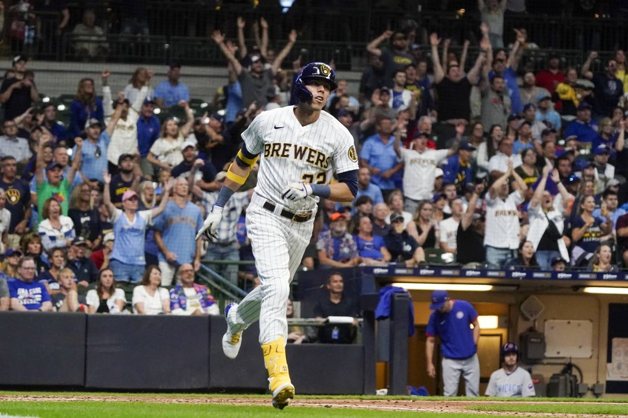 Milwaukee Brewers' Christian Yelich hits a three-run home run during the seventh inning of a baseba...