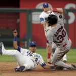 
              Boston Red Sox's Christian Arroyo (39) is caught stealing second by Kansas City Royals second baseman Nicky Lopez (8) during the sixth inning of a baseball game Saturday, Aug. 6, 2022, in Kansas City, Mo. (AP Photo/Charlie Riedel)
            