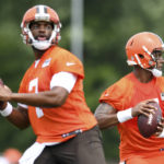 
              Cleveland Browns quarterbacks Deshaun Watson, right, and Jacoby Brissett look to pass during the NFL football team's training camp, Monday, Aug. 1, 2022, in Berea, Ohio. (AP Photo/Nick Cammett)
            