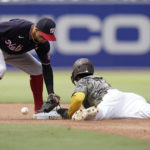 
              Washington Nationals second baseman Cesar Hernandez drops the ball as San Diego Padres' Ha-Seong Kim safely steals second base during the fourth inning of a baseball game Sunday, Aug. 21, 2022, in San Diego. (AP Photo/Gregory Bull)
            