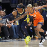 
              Connecticut Sun guard Courtney Williams (10) and Dallas Wings guard Arike Ogunbowale (24) reach for the ball during the second half of Game 3 of a WNBA first-round playoff series basketball game in Arlington, Texas, Wednesday, Aug. 24, 2022. The Sun won 73-58. (AP Photo/LM Otero)
            