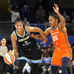 
              Chicago Sky's Candace Parker (3) brings the ball up court as Connecticut Sun's Alyssa Thomas defends during the second half in Game 1 of a WNBA basketball semifinal playoff series Sunday, Aug. 28, 2022, in Chicago. The Sun won 68-63. (AP Photo/Charles Rex Arbogast)
            