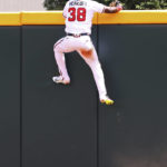 
              Atlanta Braves outfielder Guillermo Heredia climbs the wall but can't reach a three-run home run by Philadelphia Phillies Nick Castellanos during the eighth inning of a baseball game, Wednesday, Aug. 3, 2022, in Atlanta. (Curtis Compton/Atlanta Journal-Constitution via AP)
            