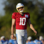 
              Los Angeles Chargers quarterback Justin Herbert (10) participates in drills at the NFL football team's practice facility in Costa Mesa, Calif. Sunday, Aug. 7, 2022. (AP Photo/Ashley Landis)
            