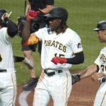 
              Pittsburgh Pirates' Oneil Cruz (15) is greeted by Bligh Madris (66) and Cal Mitchell (31) after driving them in with a three-run home run against the Milwaukee Brewers during the sixth inning of a baseball game Tuesday, Aug. 2, 2022, in Pittsburgh. (AP Photo/Keith Srakocic)
            