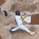 
              Milwaukee Brewers' Christian Yelich hits a two-run home run during the fourth inning of a baseball game against the Chicago Cubs Sunday, Aug. 28, 2022, in Milwaukee. (AP Photo/Morry Gash)
            
