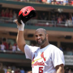 
              St. Louis Cardinals' Albert Pujols tips his cap after hitting a grand slam during the third inning of a baseball game against the Colorado Rockies Thursday, Aug. 18, 2022, in St. Louis. (AP Photo/Jeff Roberson)
            