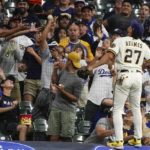 
              Milwaukee Brewers' Willy Adames can't get to a foul ball hit by Los Angeles Dodgers' Trea Turner during the third inning of a baseball game Monday, Aug. 15, 2022, in Milwaukee. (AP Photo/Morry Gash)
            