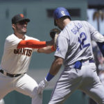 
              Los Angeles Dodgers' Joey Gallo (12) is tagged by San Francisco Giants first baseman David Villar after grounding out during the fifth inning of a baseball game in San Francisco, Thursday, Aug. 4, 2022. (AP Photo/Jeff Chiu)
            