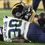
              Pittsburgh Steelers running back Jaylen Warren, top, stretches the ball over Seattle Seahawks cornerback Mike Jackson (30) for a touchdown after making a catch during the second half of an NFL preseason football game Saturday, Aug. 13, 2022, in Pittsburgh. (AP Photo/Barry Reeger)
            