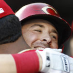 
              Cincinnati Reds' Kyle Farmer, right, hugs a teammate after hitting a solo home run during the first inning of a baseball game against the Washington Nationals, Saturday, Aug. 27, 2022, in Washington. (AP Photo/Luis M. Alvarez)
            