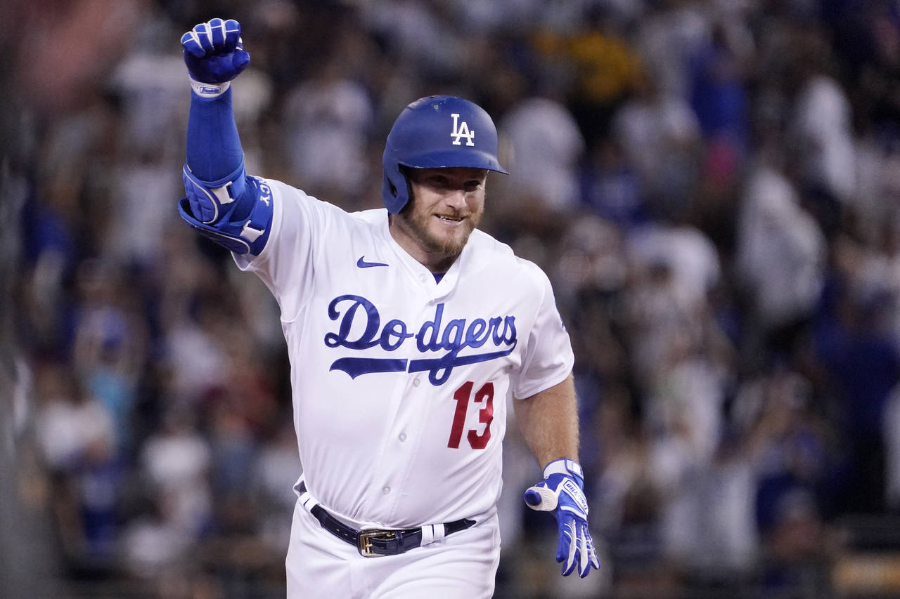 Los Angeles Dodgers' Max Muncy gestures as he rounds their after hitting a three-run home run durin...