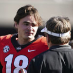 
              FILE - Georgia quarterback JT Daniels (18) talks with head coach Kirby Smart in the second half of an NCAA college football game against Charleston Southern Saturday, Nov. 20, 2021, in Athens, Ga. Daniels transferred to West Virginia from national champion Georgia, where he lost his starting job last season. (AP Photo/John Bazemore)
            