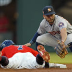 
              Atlanta Braves' Dansby Swanson (7) dives back to second base safely as Houston Astros second baseman Jose Altuve (27) handles the late throw in the forest inning of a baseball game Friday, Aug. 19, 2022, in Atlanta. (AP Photo/John Bazemore)
            