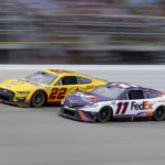 
              Denny Hamlin (11) and Joey Logano (22) race in the NASCAR Cup Series auto race at the Michigan International Speedway in Brooklyn, Mich., Sunday, Aug. 7, 2022. (AP Photo/Paul Sancya)
            