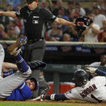 
              Minnesota Twins' Nick Gordon, right, scores past Toronto Blue Jays relief pitcher Tim Mayza, left, on a squeeze play in the sixth inning of a baseball game Saturday, Aug. 6, 2022, in Minneapolis. Mayza was hurt on the play and left the game. (AP Photo/Bruce Kluckhohn)
            