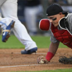 
              Boston Red Sox catcher Reese McGuire dives on the ball hit by Kansas City Royals' Salvador Perez before throwing him out at first base during the third inning of a baseball game Friday, Aug. 5, 2022, in Kansas City, Mo. (AP Photo/Reed Hoffmann)
            