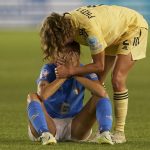 
              FILE - Belgium's Davina Philtjens comforts Italy's Manuela Giugliano sitting on the ground at the end of the Women Euro 2022 group D soccer match between Italy and Belgium at the Manchester City Academy Stadium, in Manchester, England, Monday, July 18, 2022. Belgium won 1-0 to advance to the quarterfinals. (AP Photo/Jon Super, File)
            