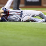 
              Atlanta Braves starting pitcher Max Fried lies on the ground after New York Mets' Francisco Lindor and Starling Marte scored during the third inning of the second game of a baseball doubleheader on Saturday, Aug. 6, 2022, in New York. (AP Photo/Jessie Alcheh)
            