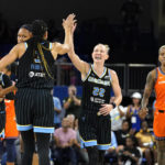 
              Chicago Sky's Courtney Vandersloot (22) celebrates with Candace Parker after scoring as Connecticut Sun's Courtney Williams (10) walks by during the first half of Game 2 in a WNBA basketball playoffs semifinal Wednesday, Aug. 31, 2022, in Chicago. (AP Photo/Nam Y. Huh)
            