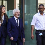 
              Former Formula One boss, Bernie Ecclestone, leaves Westminster Magistrates Court, in London, Monday, Aug. 22, 2022. Bernie Ecclestone has been charged with fraud by false representation over an alleged failure to declare £400 million of overseas assets to the Government. (AP Photo/Alberto Pezzali)
            