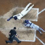 
              Milwaukee Brewers' Tyrone Taylor slides safely past Los Angeles Dodgers catcher Austin Barnes during the eighth inning of a baseball game Wednesday, Aug. 17, 2022, in Milwaukee. Taylor scored on a hit by Christian Yelich. (AP Photo/Morry Gash)
            