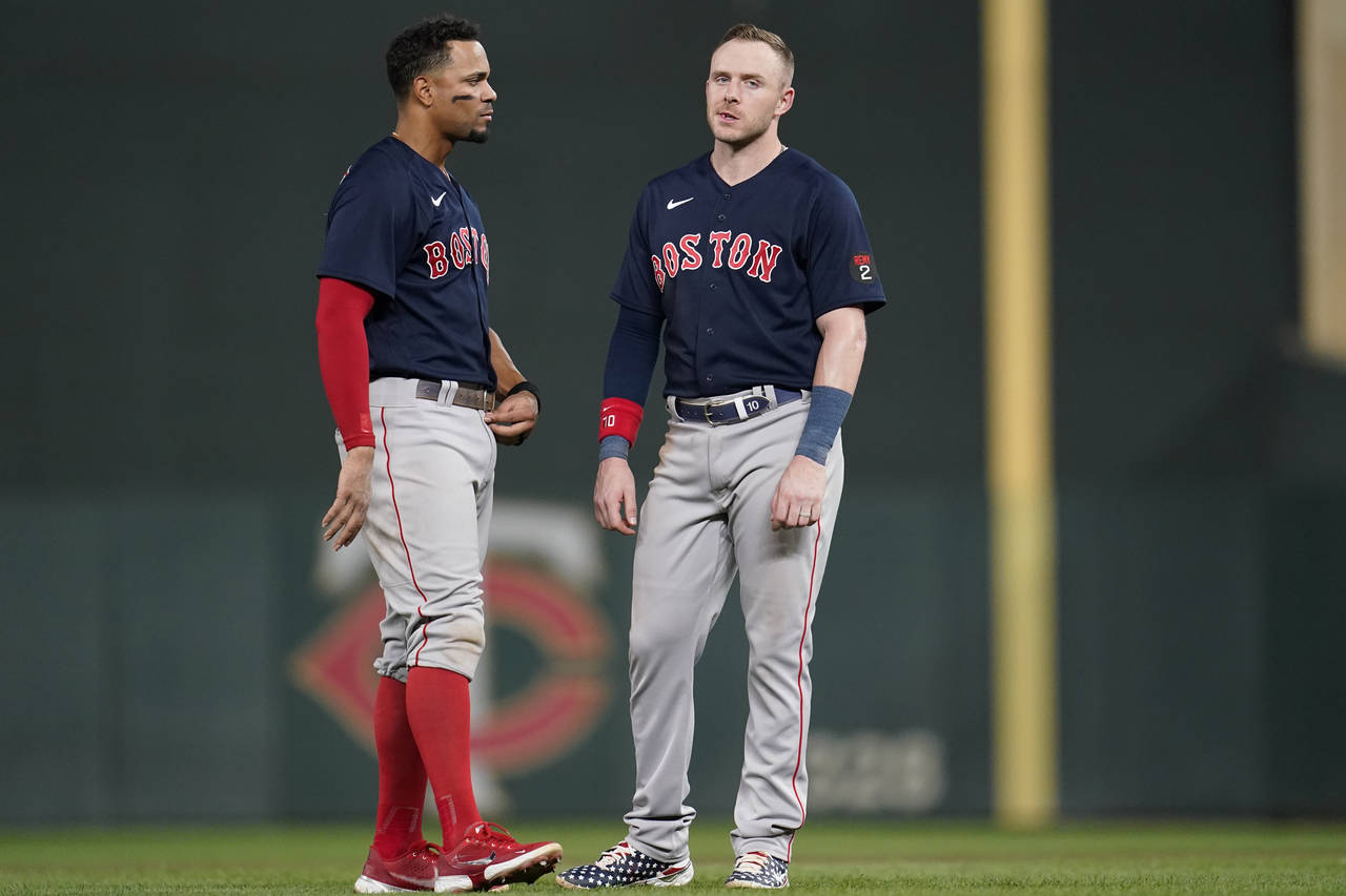 Boston Red Sox's Xander Bogaerts, left, and Boston Red Sox's Trevor Story, right, react after the t...