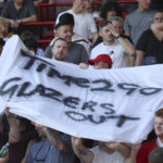 
              Some Manchester United fans hold up a banner protesting again not the current owners of the club ahead of the English Premier League soccer match between Brentford and Manchester United at the Gtech Community Stadium in London, Saturday, Aug. 13, 2022. (AP Photo/Ian Walton)
            