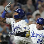 
              Kansas City Royals' Salvador Perez celebrates with third base coach Vance Wilson after hitting a three-run home run during the seventh inning of a baseball game against the Boston Red Sox Thursday, Aug. 4, 2022, in Kansas City, Mo. (AP Photo/Charlie Riedel)
            