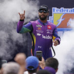 
              Bubba Wallace greets fans during driver introductions prior to a NASCAR Cup Series auto race at Richmond Raceway, Sunday, Aug. 14, 2022, in Richmond, Va. (AP Photo/Steve Helber)
            