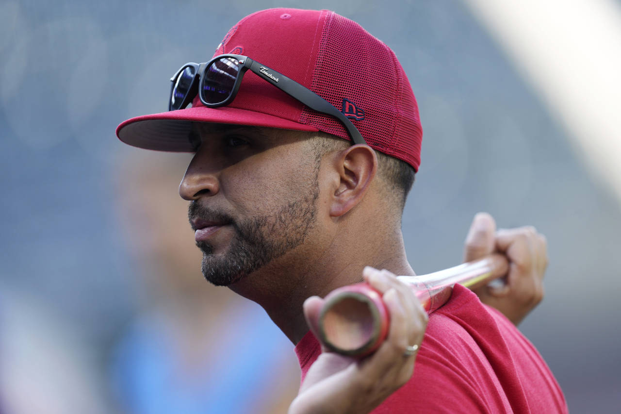 St. Louis Cardinals manager Oliver Marmol watches players warm up for a baseball game against the C...