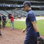 
              Seattle Mariners former baseball player Ichiro Suzuki, walks to the dugout past video cameras before a baseball game against the Cleveland Guardians, Friday, Aug. 26, 2022, in Seattle. Suzuki is to be inducted into the Mariners Hall of Fame. (AP Photo/John Froschauer)
            