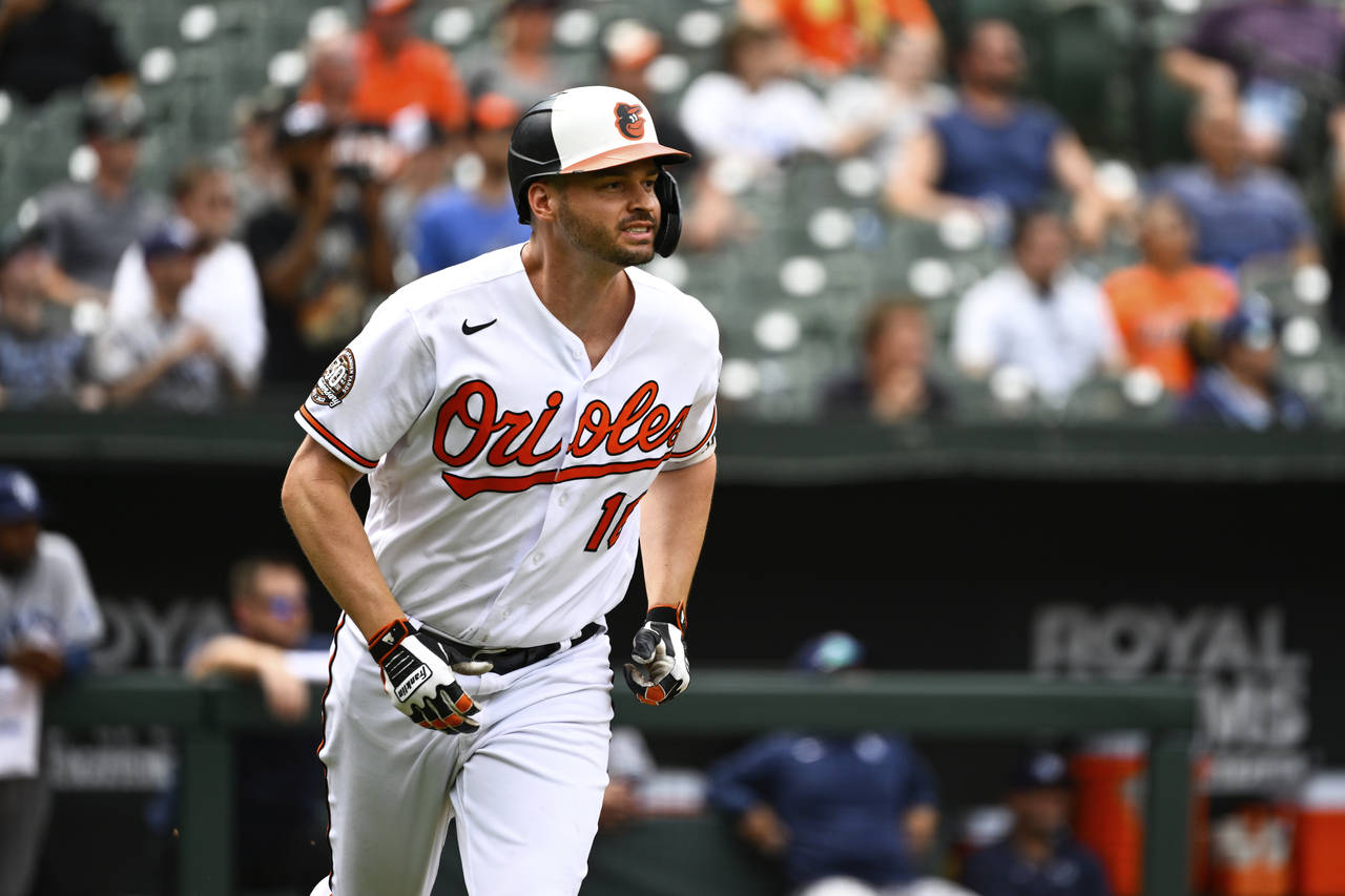 Baltimore Orioles designated hitter Trey Mancini watches his inside the park home run hit against T...