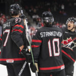 
              Canada's Will Cuylle (27), Logan Stankoven (10) and Donovan Sebrango celebrate a goal against Switzerland during the second period in a quarterfinal in the IIHF junior world hockey championships Wednesday, Aug. 17, 2022, in Edmonton, Alberta. (Jason Franson/The Canadian Press via AP)
            