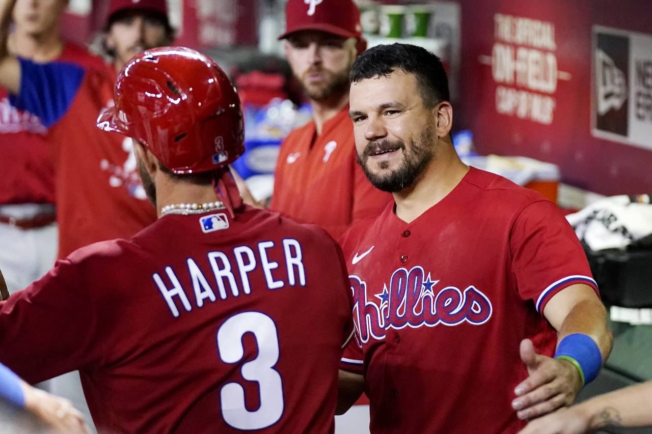 Philadelphia Phillies' Bryce Harper (3) is congratulated by Kyle Schwarber, right, after Harper sco...