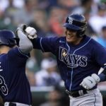 
              Tampa Bay Rays' Yu Chang is greeted by Brandon Lowe after a solo home run during the second inning of a baseball game against the Detroit Tigers, Saturday, Aug. 6, 2022, in Detroit. (AP Photo/Carlos Osorio)
            