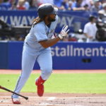 
              Toronto Blue Jays' Vladimir Guerrero Jr. runs out a ground rule double off Cleveland Guardians starting pitcher Triston McKenzie in first-inning baseball game action in Toronto, Saturday, Aug. 13, 2022. (Jon Blacker/The Canadian Press via AP)
            