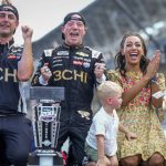 
              Tyler Reddick, center, and Alexa De Leon, right, celebrate after kissing the bricks following Reddick's win in the NASCAR Cup Series auto race at Indianapolis Motor Speedway, Sunday, July 31, 2022, in Indianapolis. (AP Photo/AJ Mast)
            