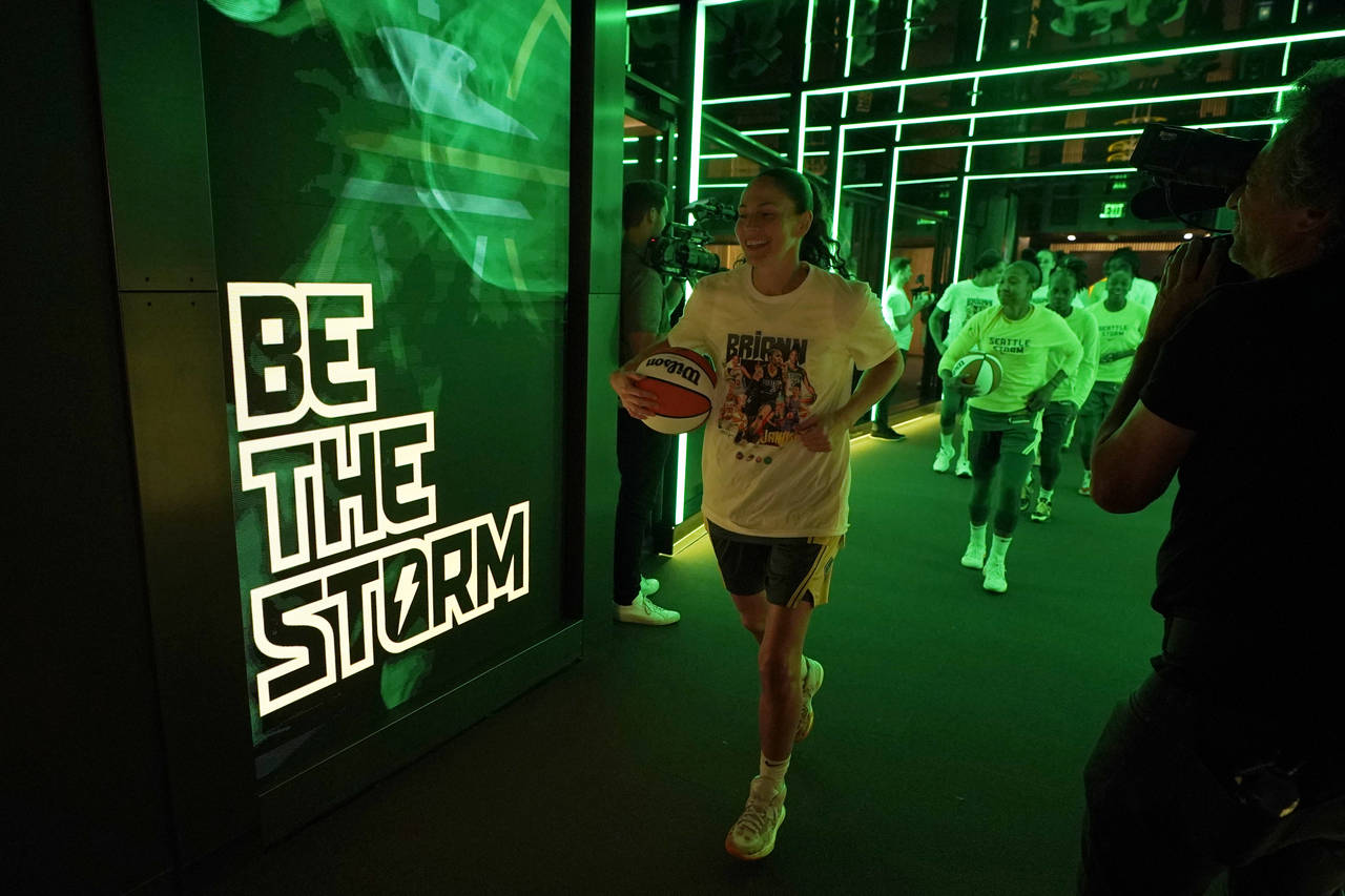 Seattle Storm guard Sue Bird, center, walks out of the tunnel before a WNBA basketball game against...
