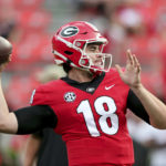 
              FILE - Then-Georgia quarterback JT Daniels (18) warms up for the team's NCAA college football game against South Carolina on Saturday, Sept. 18, 2021, in Athens, Ga. Daniels is now quarterback at West Virginia. The Backyard Brawl returns after a 10-year hiatus on Thursday night when 17th-ranked Pitt hosts West Virginia. (AP Photo/Butch Dill, File)
            