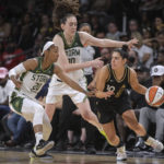 
              Las Vegas Aces guard Kelsey Plum (10) is defended by Seattle Storm guard Briann January (20) and forward Breanna Stewart (30) during the second half of a WNBA game Sunday, Aug. 14, 2022, in Las Vegas. (AP Photo/Sam Morris)
            