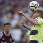 
              Manchester City's Kevin De Bruyne heads the ball during their English Premier League soccer match between West Ham United and Manchester City at the London Stadium in London, England, Sunday, Aug. 7, 2022. (AP Photo/Frank Augstein)
            