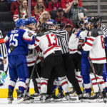 
              Canada and Slovakia rough it up during the first period of an IIHF world junior hockey championships game Thursday, Aug. 11, 2022, in Edmonton, Alberta. (Jason Franson/The Canadian Press via AP)
            